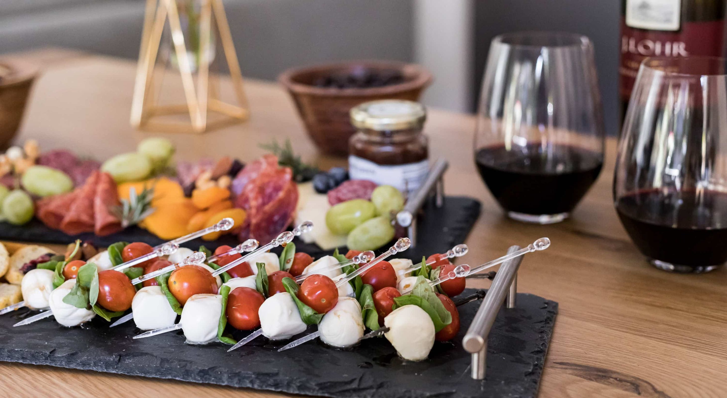 Enticing appetizer platter with wine, dining experience in a cozy mountain retreat.
