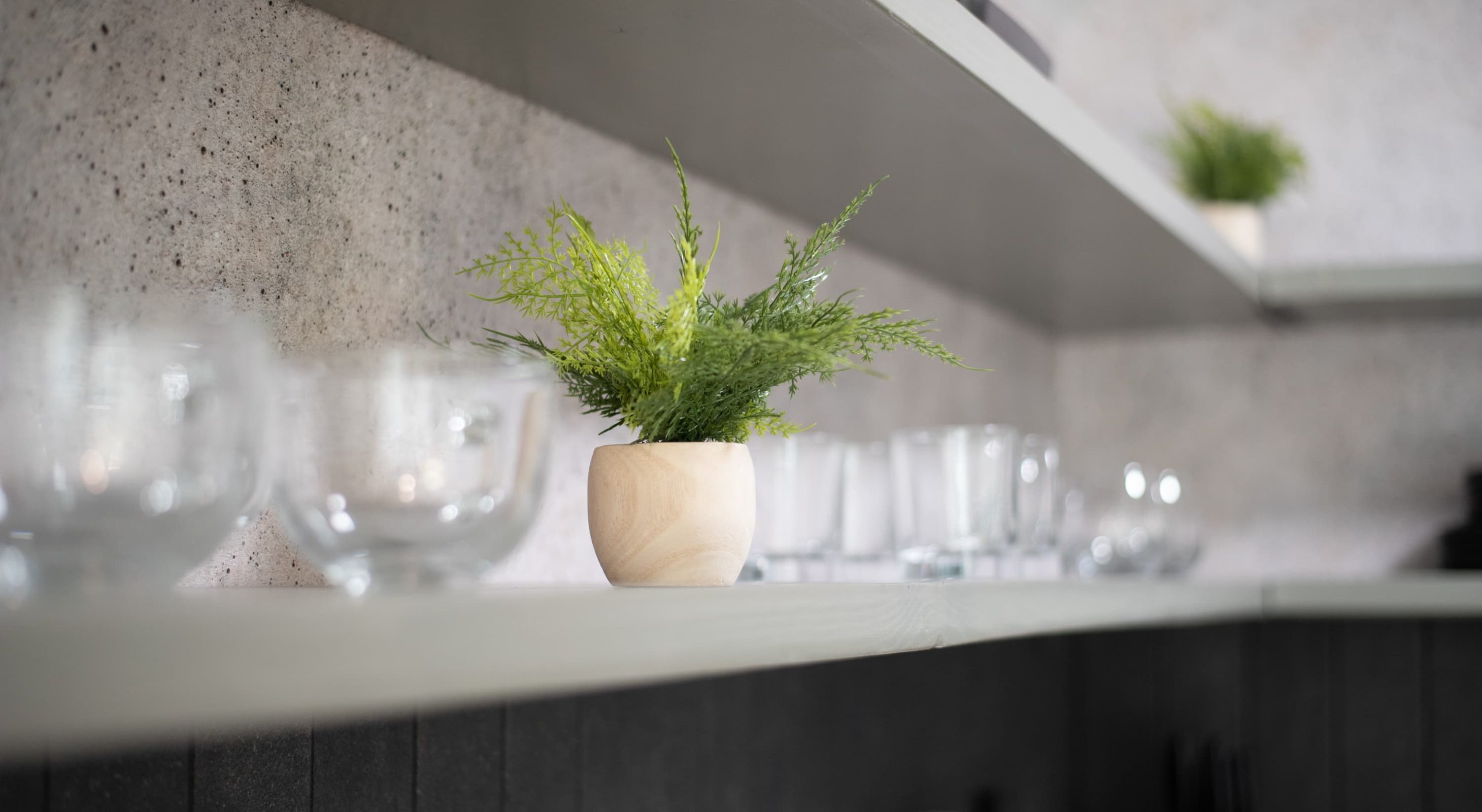 Stylish shelf with glassware and greenery in a boutique hotel near The Village.