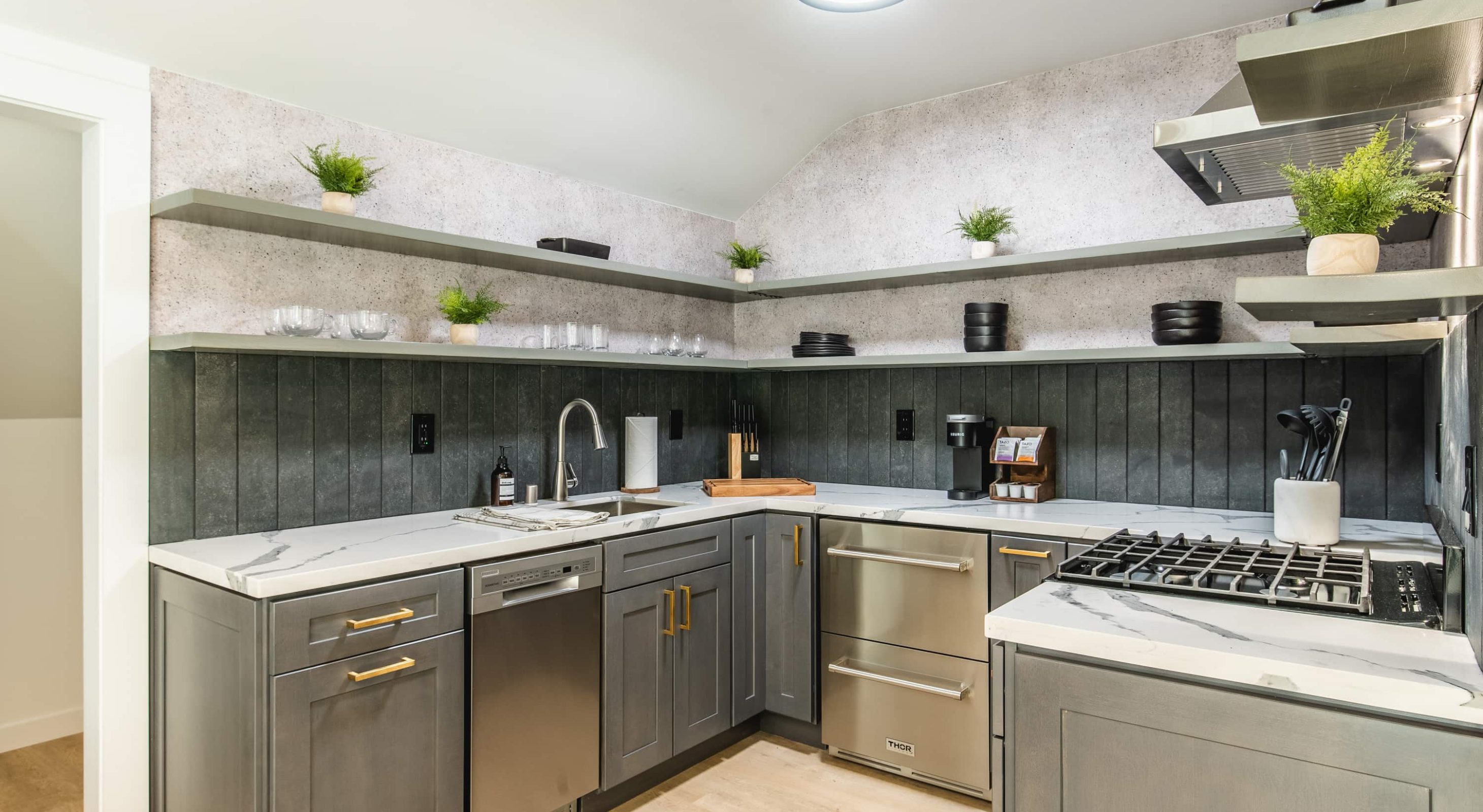 Modern kitchen in a Place to Stay in Lake Arrowhead, featuring sleek gray cabinets.