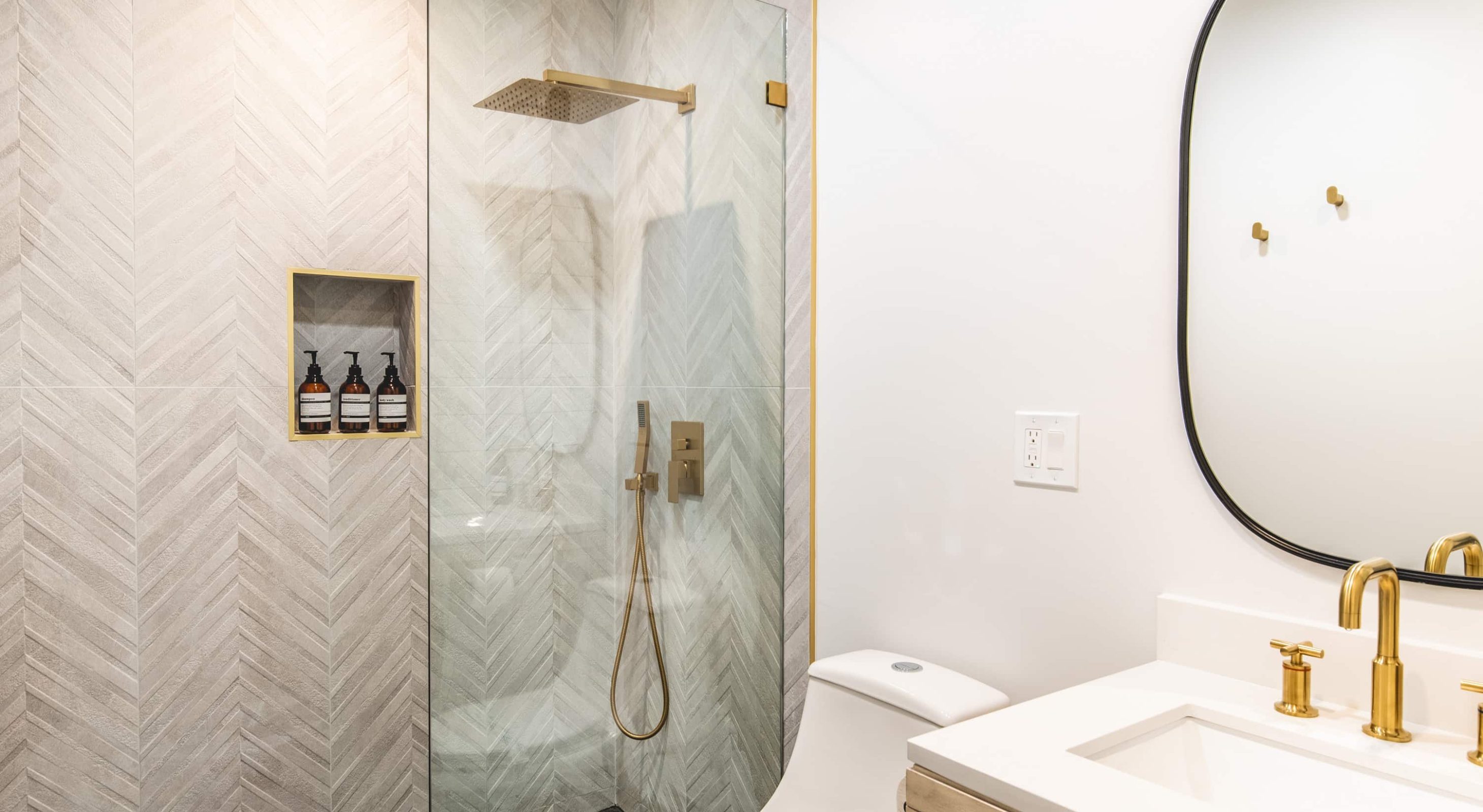 Modern bathroom with stylish gold fixtures in a Lake Arrowhead lodging suite.