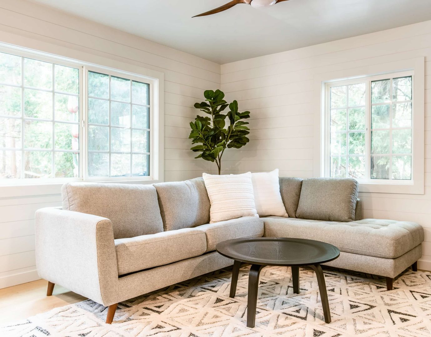 Cozy mountain retreat with a modern sofa and natural decor for a Lake Arrowhead escape.