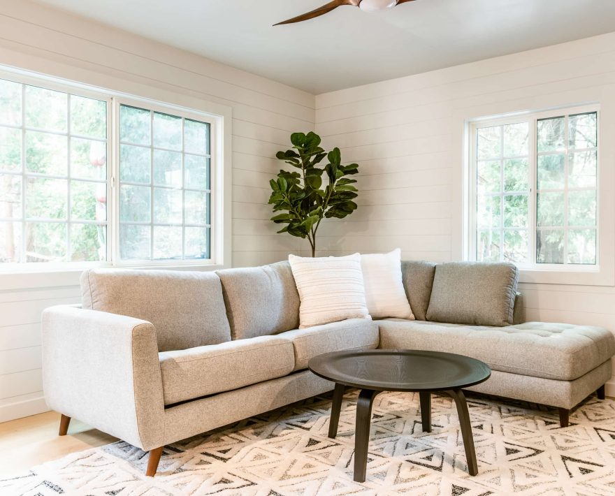 Cozy mountain retreat with a modern sofa and natural decor for a Lake Arrowhead escape.