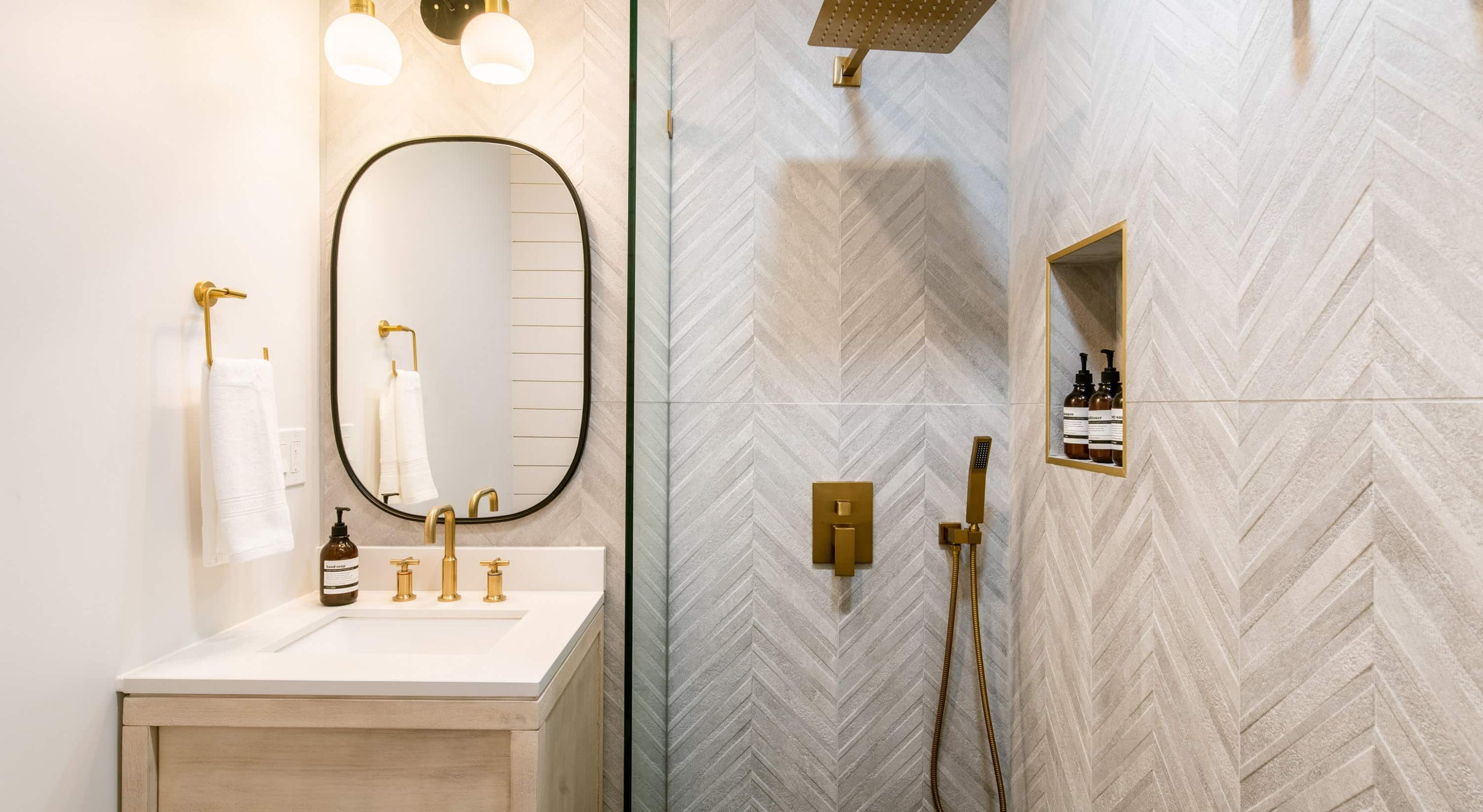 Modern bathroom design at a Cozy Mountain Retreat featuring elegant gold fixtures.