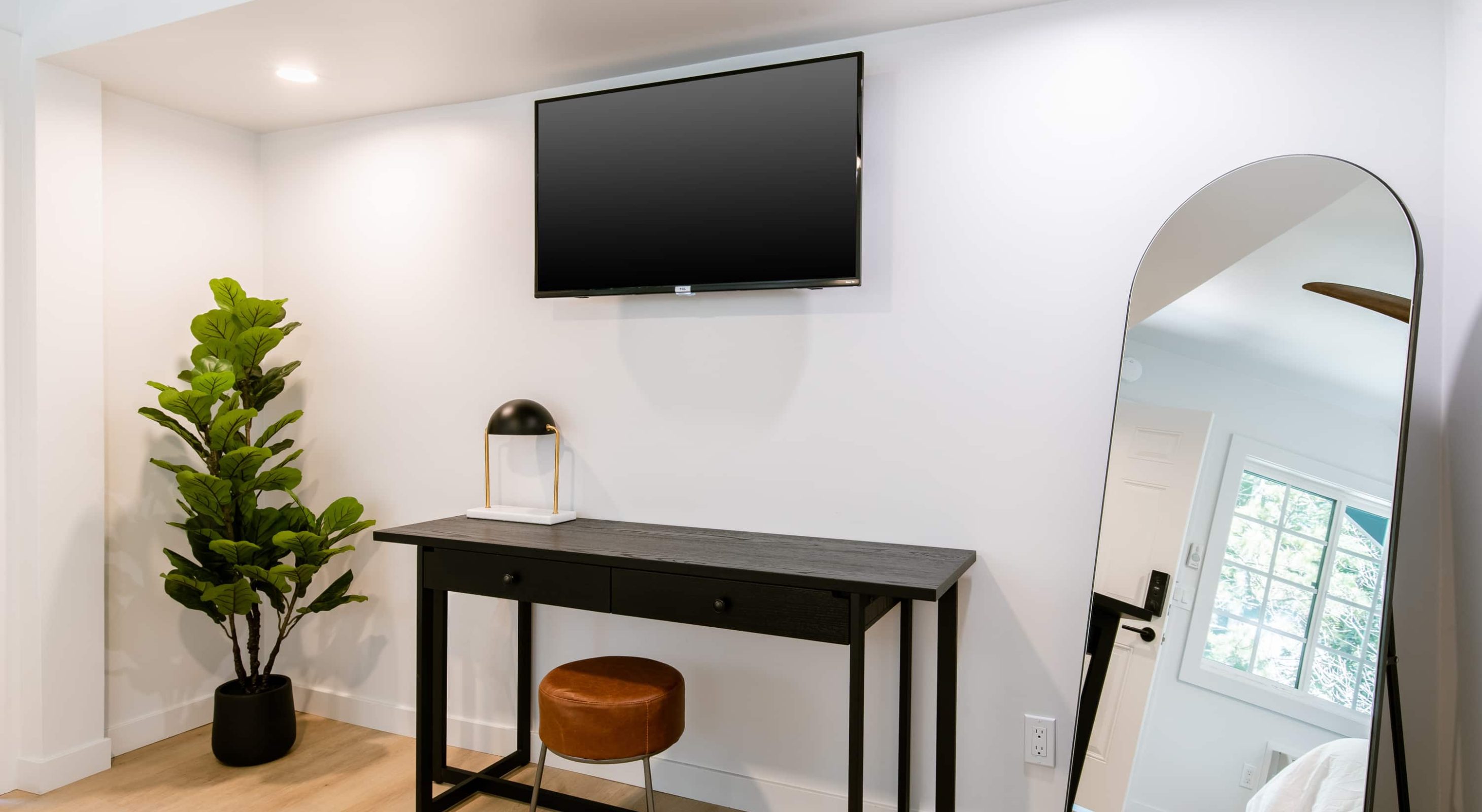 Modern room decor in a Cozy Mountain Retreat, featuring a sleek desk and mirror.