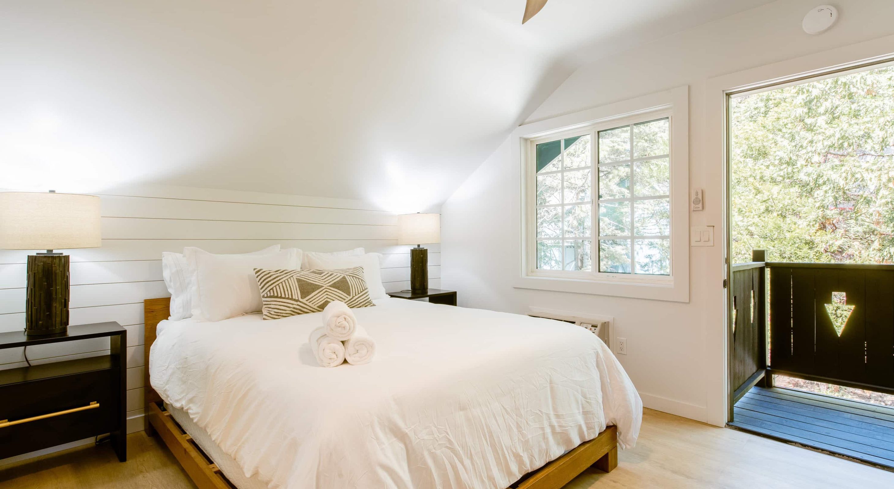 Cozy bedroom with a serene view at a boutique hotel near the Village in Lake Arrowhead.