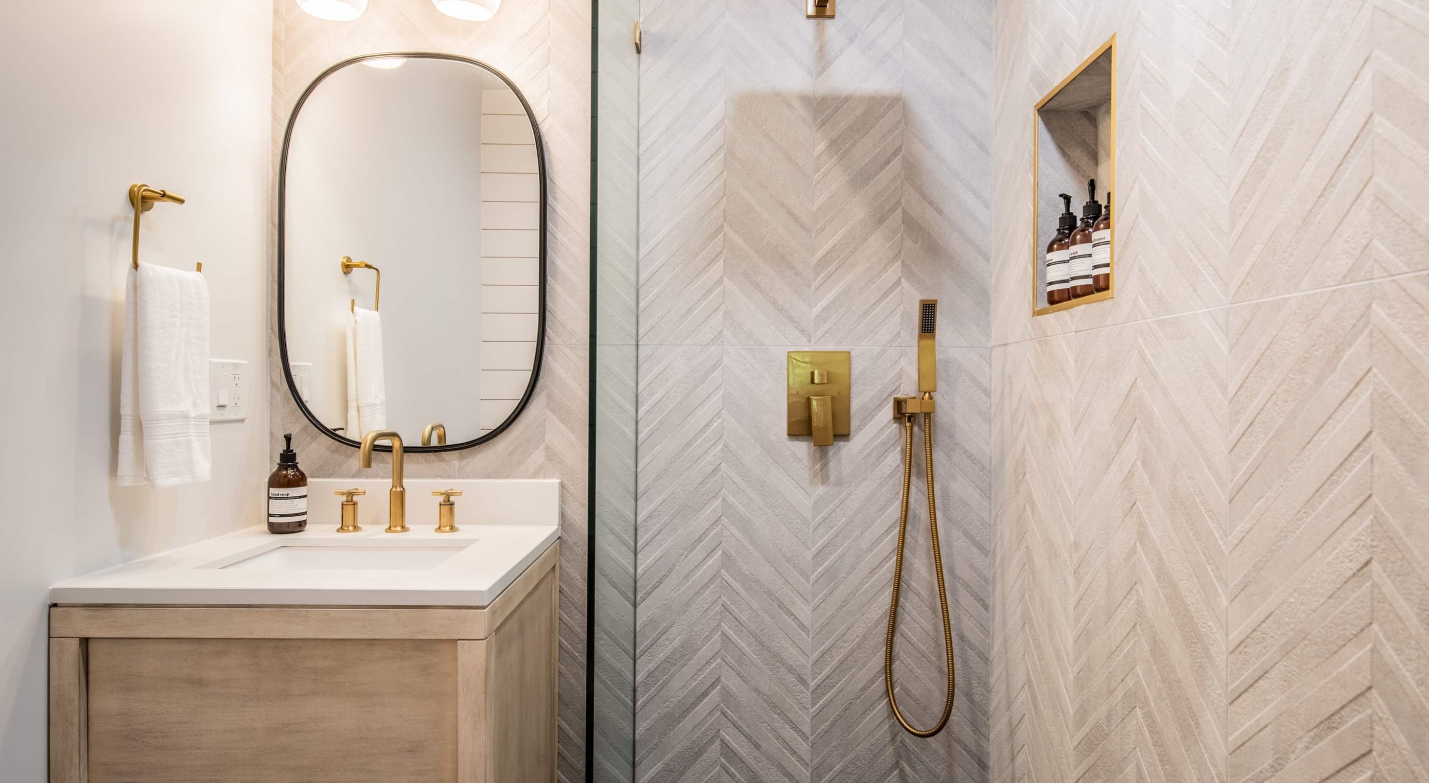 Elegant bathroom in a Boutique Hotel near The Village, featuring modern gold fixtures.