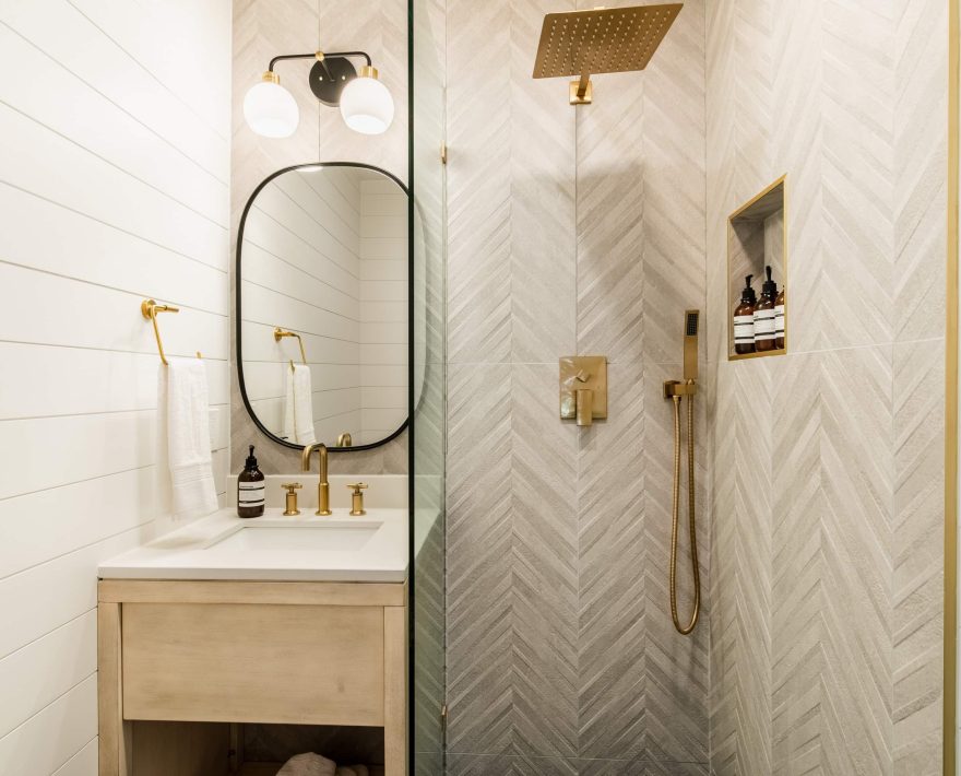 Modern bathroom at a Boutique Hotel near The Village, featuring gold fixtures.