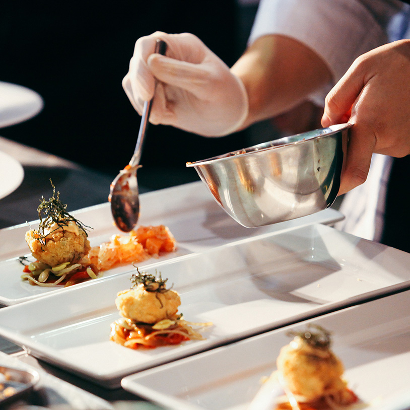 Chef meticulously prepares gourmet dishes, perfect for a Lake Arrowhead Family Vacation.
