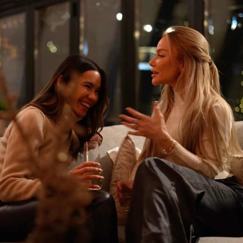 Two women sitting on the sofa in the Kingsley's clubhouse in Lake Arrowhead