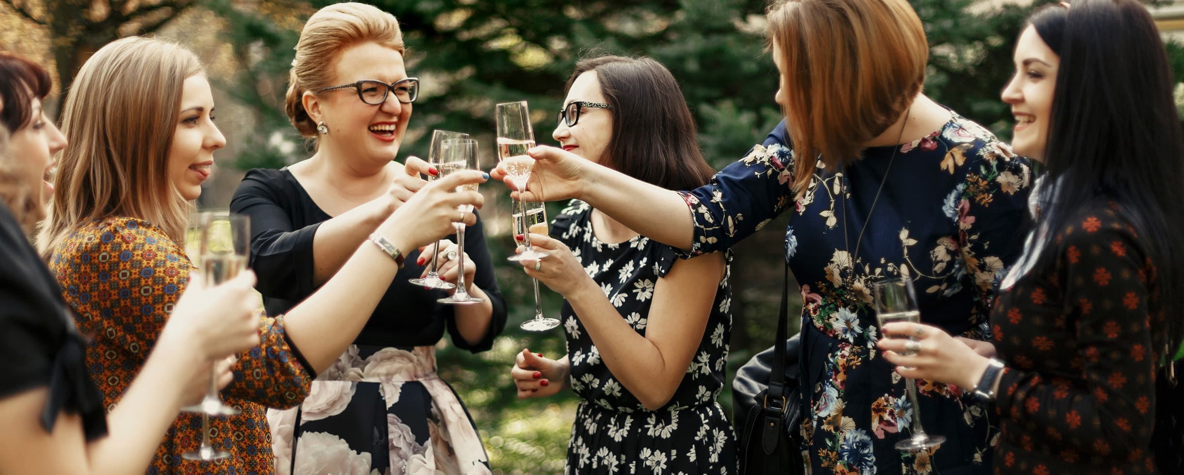 Group of women toasting with champagne, enjoying a Lake Arrowhead escape together.