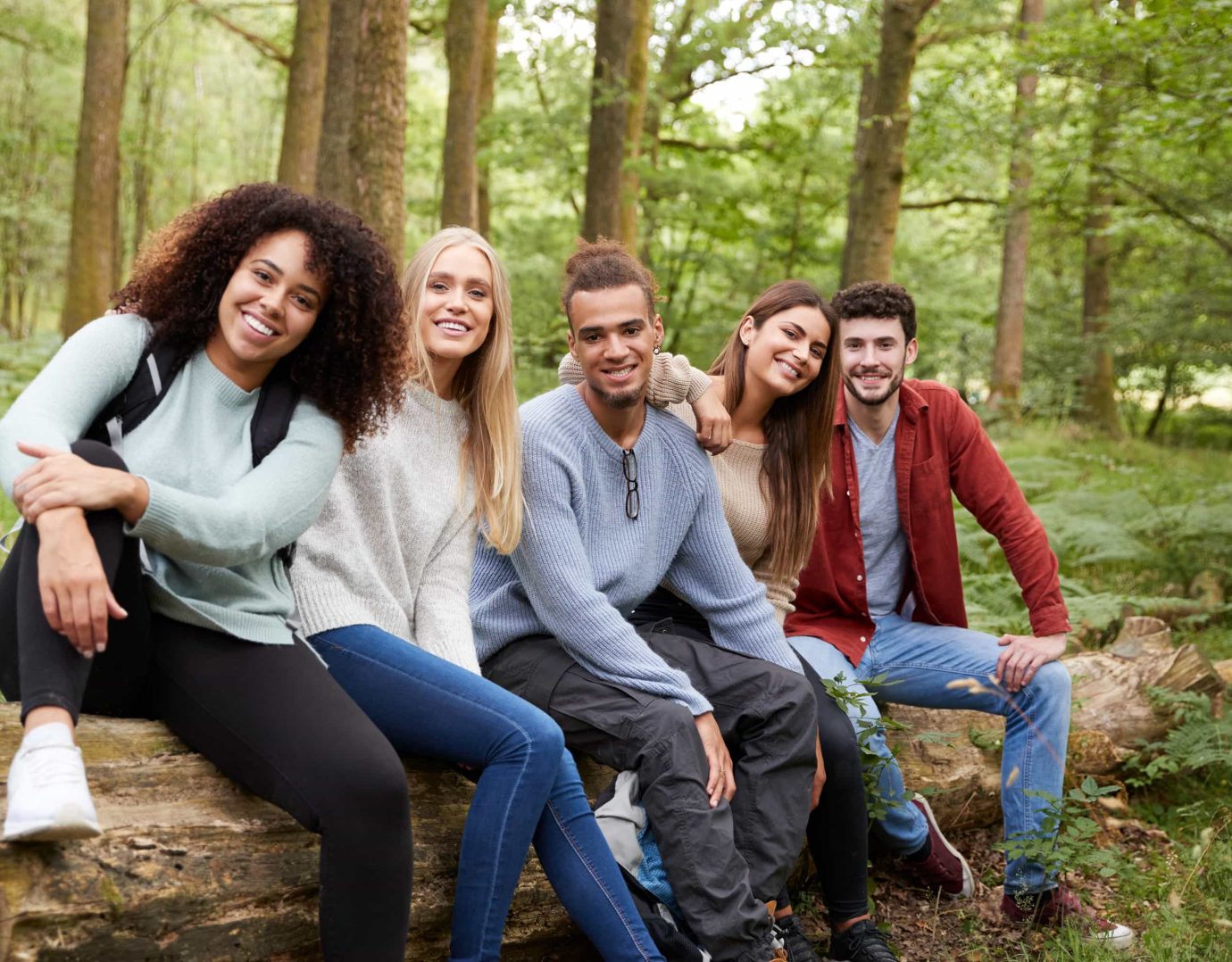 Group enjoying nature on a log, a Lake Arrowhead family vacation retreat.
