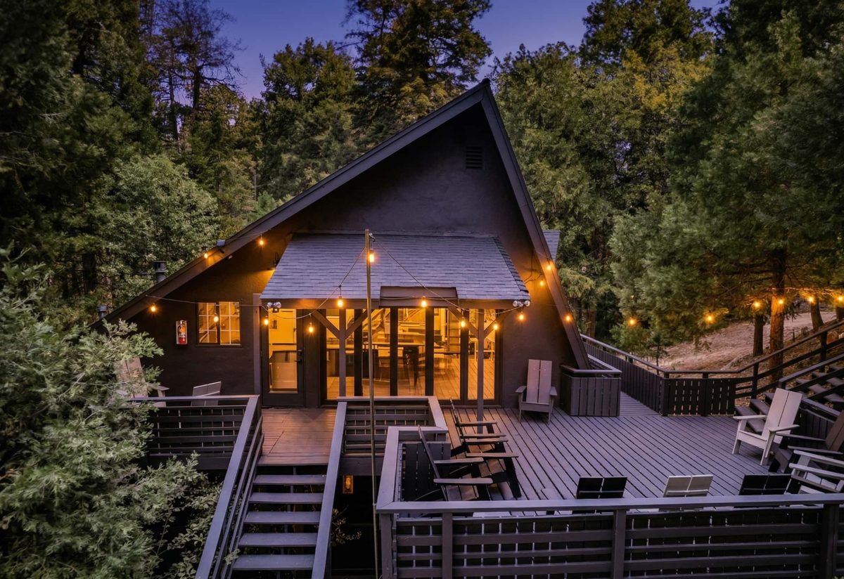 Exterior of Lake Arrowhead mountain hotel with large deck and lush trees