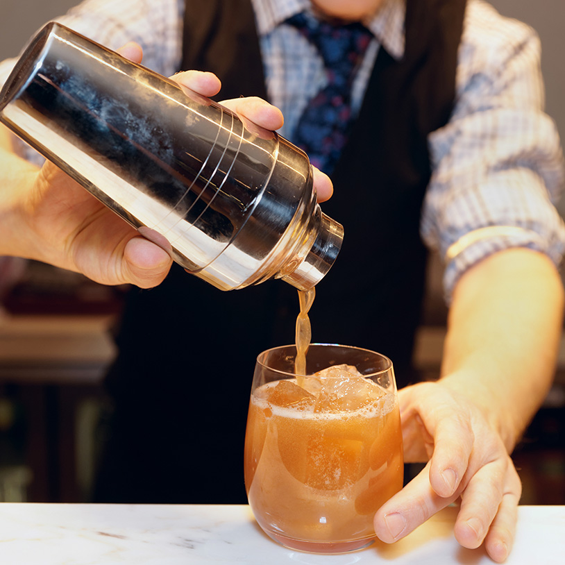 Bartender crafting a cocktail at The Kingsley Hotel, a top place to stay in Lake Arrowhead.