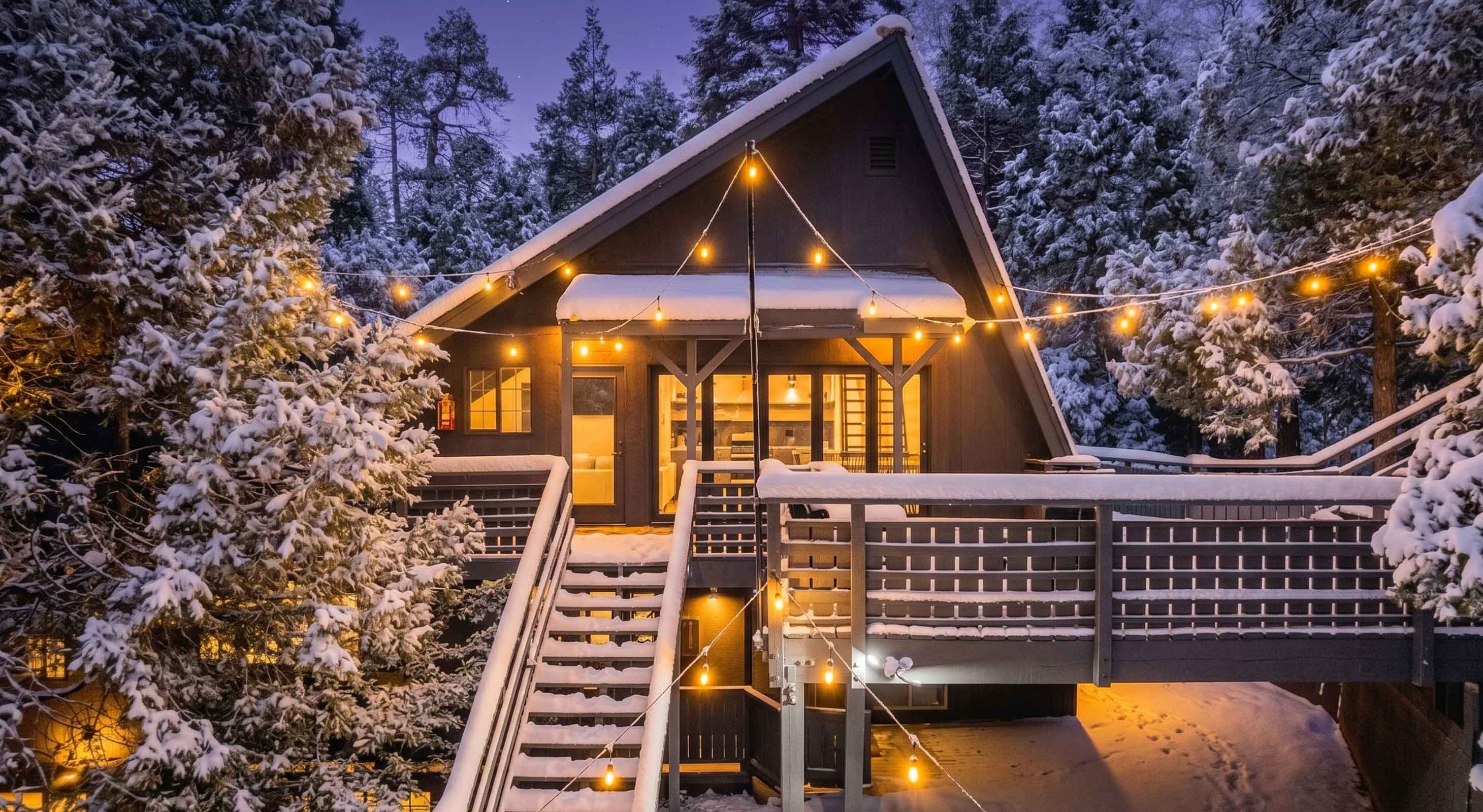 Exterior of The Kingsley Hotel with strings of patio lights in winter snow
