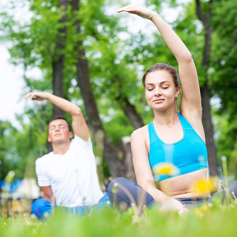 People practicing yoga outdoors, perfect for a Lake Arrowhead Family Vacation retreat.